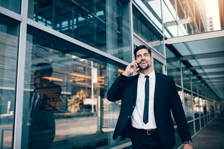 Smiling businessman talking on cell phone
