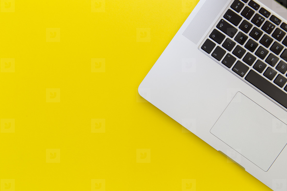 Laptop computer on bright yellow background stock photo (131118) -  YouWorkForThem