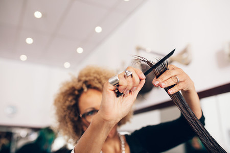 Female hair stylist cutting woman 039 s hair at salon