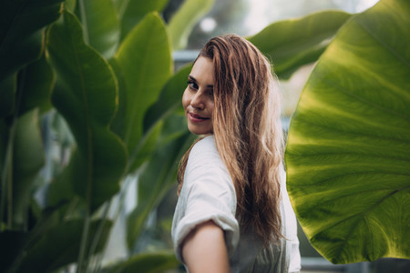 Portrait of beautiful model in greenhouse