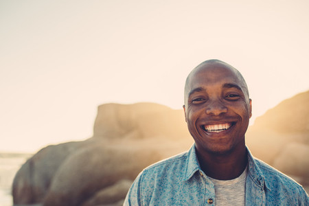 African man smiling on the beach