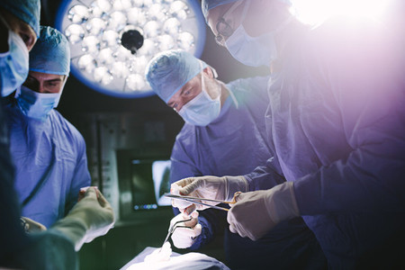 Doctors team performing surgical procedure in operating theater