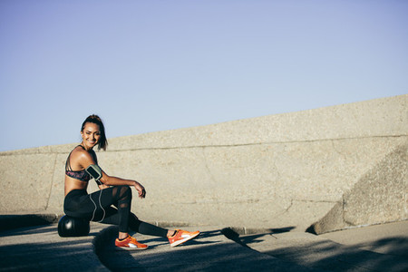 Woman resting on a fitness ball after workout
