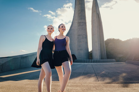 Female ballet dancers posing for photograph outdoors