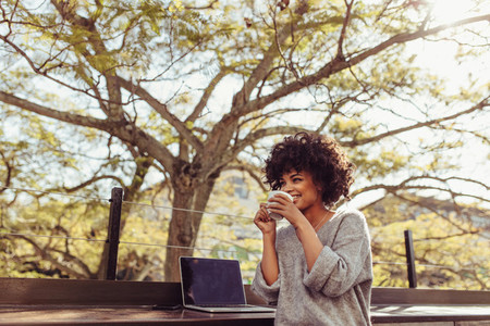 Woman drinking coffee outdoors