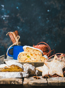 Traditional German Christmas cake Stollen with gingerbread cookies copy space