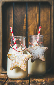 Bottles with milk for Santa and Christmas festive gingerbread cookies