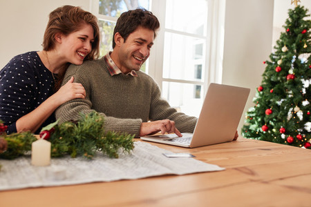 Couple buying christmas gifts online