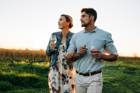 Couple with a glass of wine at vineyard outdoors