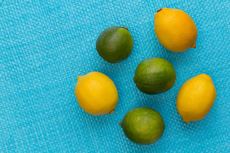 Lemon and lime on bright blue background