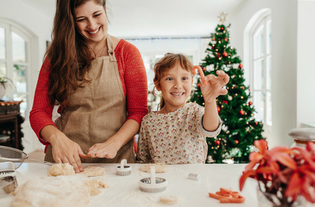Mother and daughter making cookies for Christmas