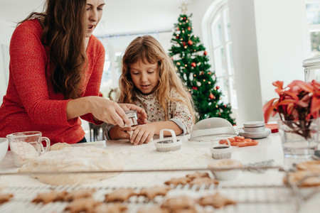 Mother and daughter preparing Christmas cookies