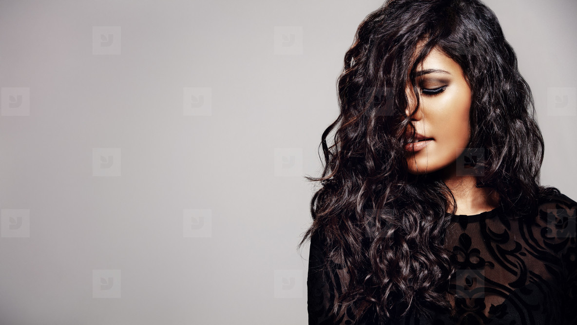 Sensual woman with shiny curly hair