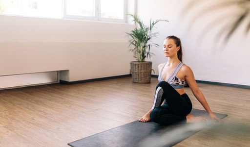 Healthy woman doing yoga indoors