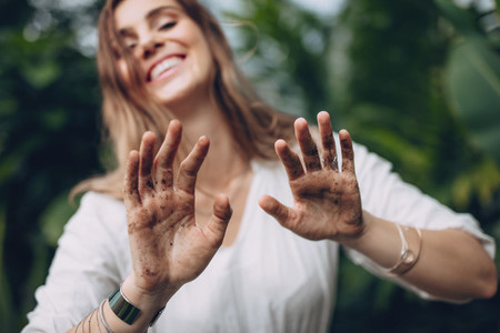 Female gardener showing her dirty hands