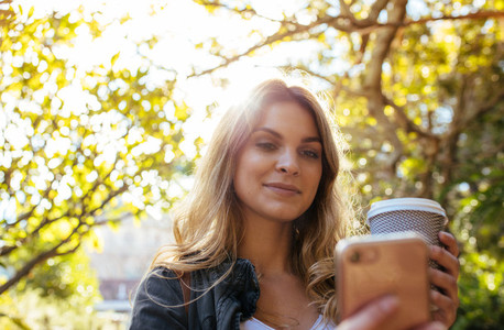 Woman clicking a selfie holding a coffee glass