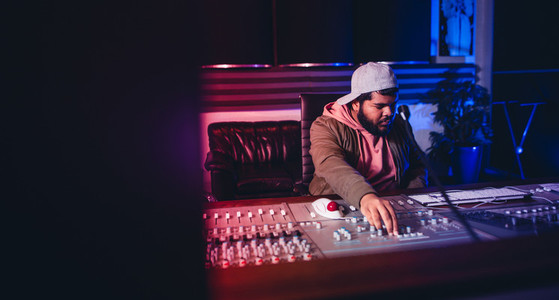 Engineer working on sound mixing desk in recording studio