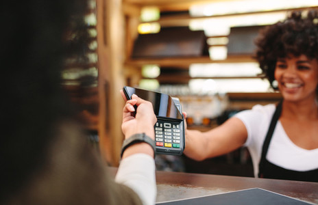 Customer paying bill using smartphone