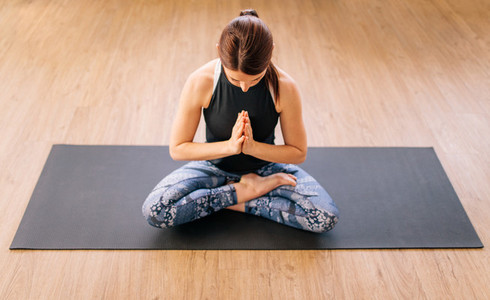 Woman in ardha padmasana yoga pose
