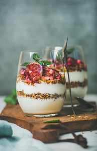 Healthy breakfast glasses with yougurt granola and orange layered parfait