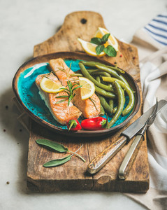 Roasted salmon fish with lemon  rosemary  chilli pepper and beans