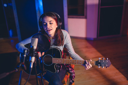 Woman performing in a recording studio