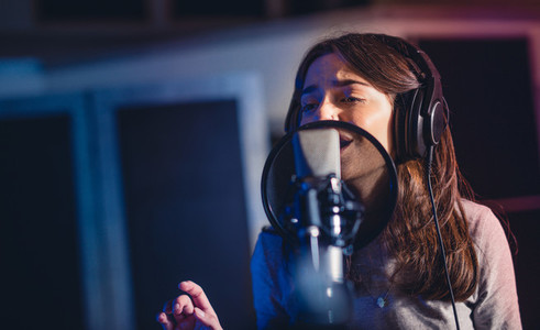 Woman recording a song for her new album