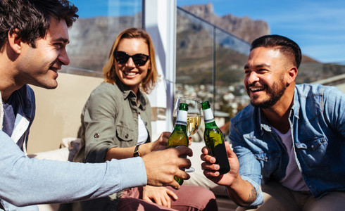 Millennial having beers at rooftop party
