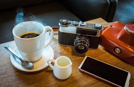 Vintage camera with coffee cup