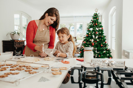 Mother and daughter making Christmas cookies