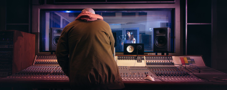 Musicians producing music in professional recording studio