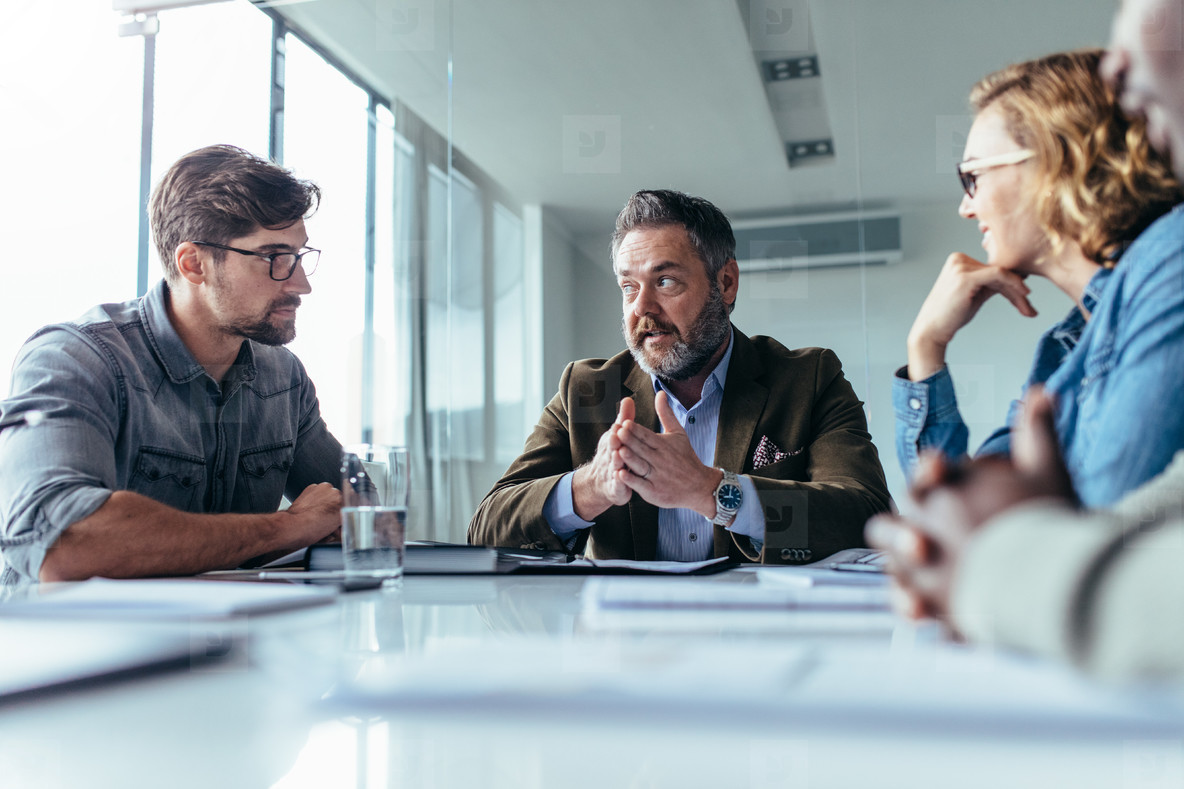 Successful businessman discussing with team in meeting