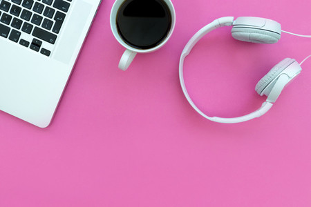 Music headphones computer keyboard laptop   coffee on pink backg