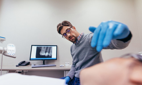 Stomatologist examining teeth of female patient