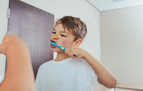 Little  boy brushing teeth in bathroom