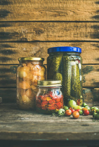 Autumn pickled vegetables in glass jars  copy space