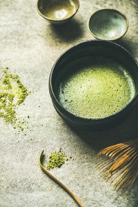 Flat lay of freshly brewed Japanese matcha green tea in bowl