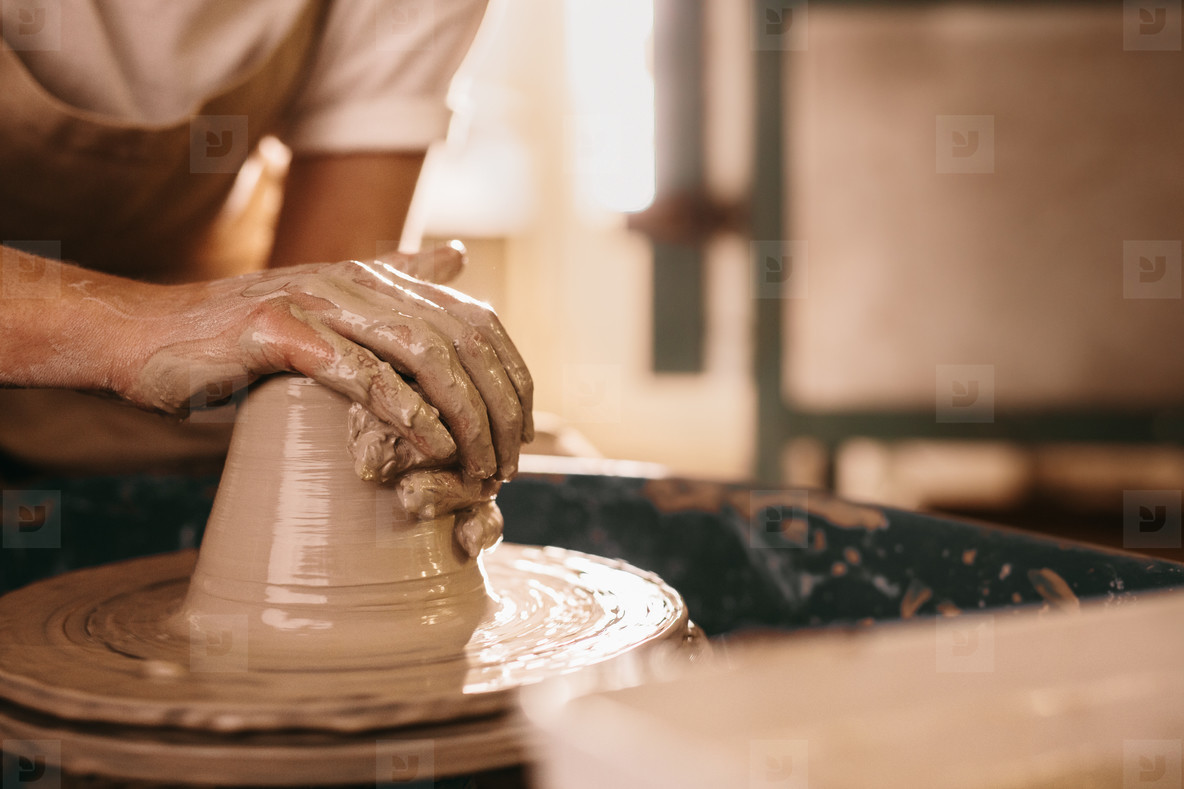 Potter moulding clay on pottery wheel stock photo (133732) - YouWorkForThem
