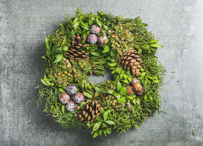Christmas decorative wreath over grey concrete wall background