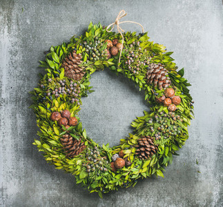 Christmas decorative wreath over concrete wall background