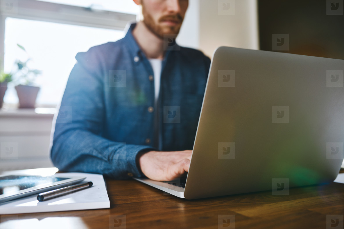 Close up view of man working on laptop