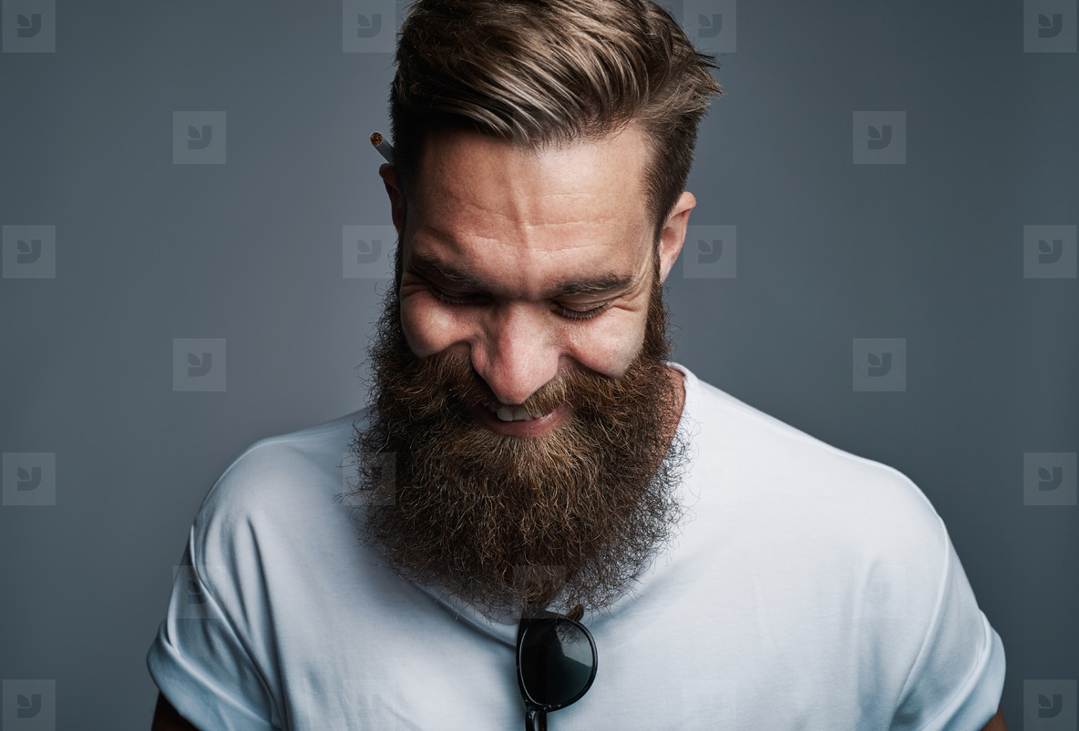 Giggling young man with large fuzzy beard