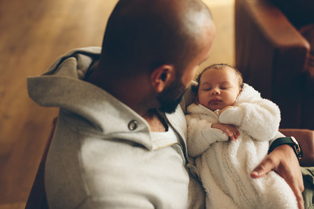 Newborn baby boy in his father039s arms