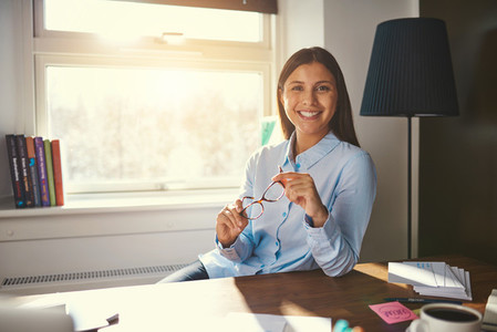Relaxed business woman sitting at desk