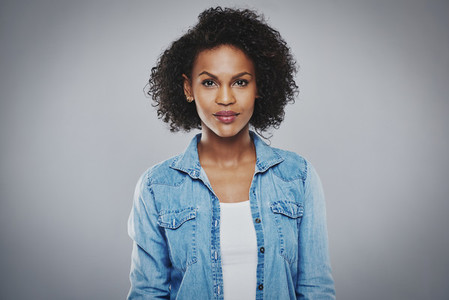 Serious black woman with blue jean shirt