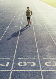 Sprinter standing on running track