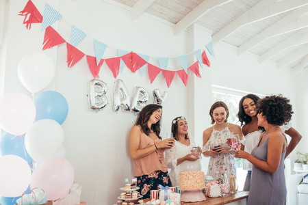 Pregnant woman celebrating baby shower with friends