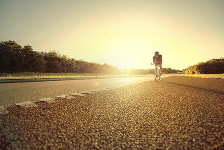 Person moving on bicycle on empty road