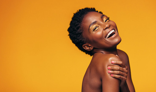 Cheerful african woman with makeup