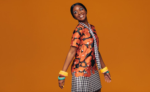 African fashion model on orange background